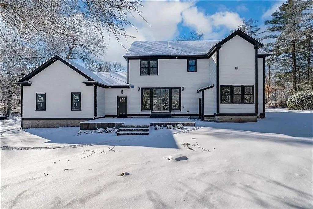 A modern farmhouse built on the South Shore, photographed after a snowfall