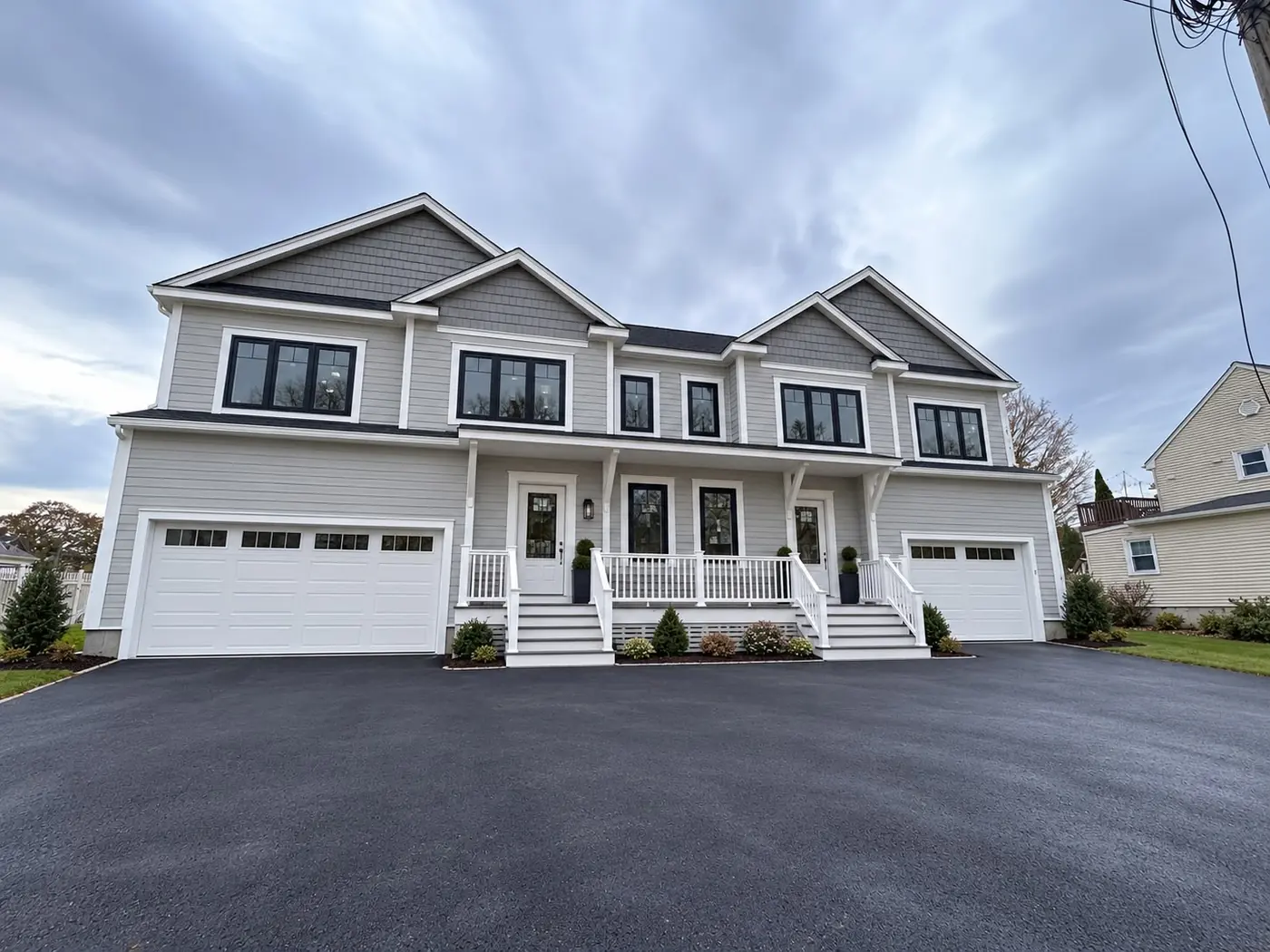 Lap siding and trim finished across a wide South Shore elevation